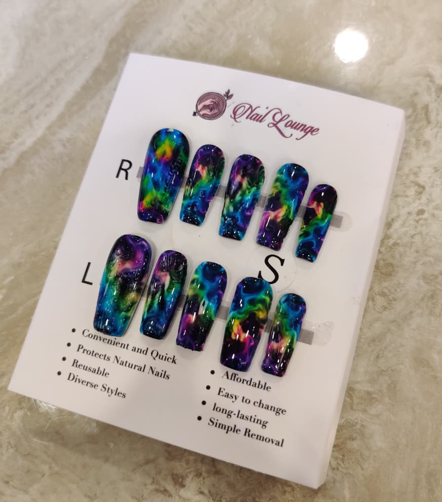 A set of colorful press-on nails displayed on a white retail card labeled 'Nail Lounge,' photographed on a light marble-like surface.